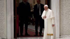 Pope Francis (R) blesses worshippers as he arrives to hold a general audience in Paul VI Hall at the Vatican.