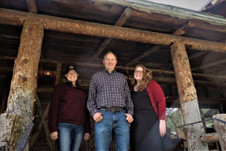 From left to right: Tawnya Rupe, Senior Program Director for AMB West Philanthropies, Yancy Arterburn, AMB West General Manager and Ashley Henrich, Human Resources stand at the entrance to the main lodge at the Mountain Sky Guest Ranch in Paradise Valley.