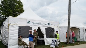 People standing outside tent
