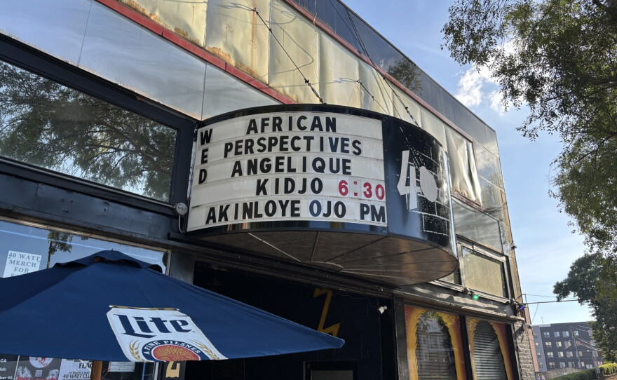 The exterior marquee of a music venue displays an announcement for African Perspectives with Angélique Kidjo and Akinloye Ojo.