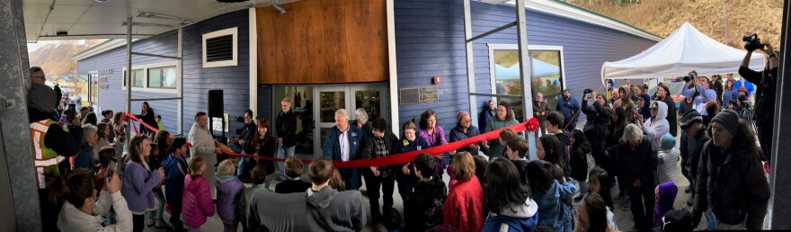 Unalaskans watch the ribbon-cutting ceremony before heading in to check out the renovated Unalaska Public Library on April 30, 2023