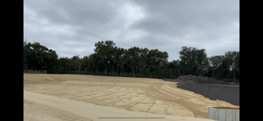 A new containment wall is nearly installed on the Cabot side of the toxic site in Gainesville. (Karmiyis Edwards/WUFT News)