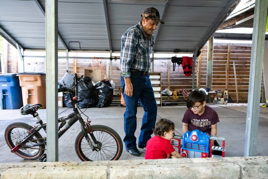 Rivera's father, Juan Manuel Rivera, watches her boys, Elias and Jair, at her Montopolis home. 