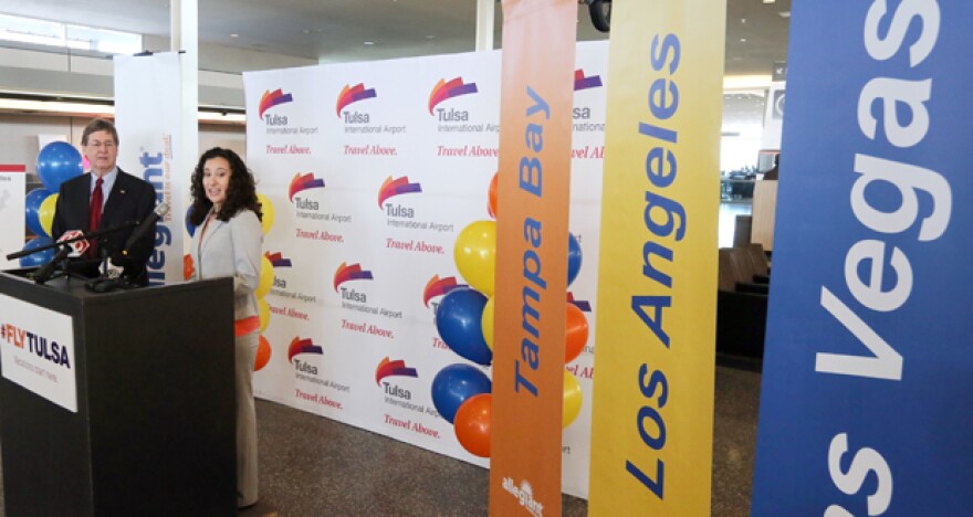 Tulsa Mayor Dewey Bartlett, left, and Laura Billiter, public relations specialist for Allegiant Air, announce three new nonstop flights from Tulsa International Airport.