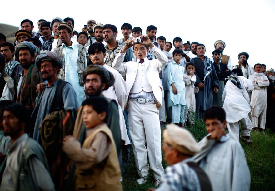 Afghan president Hamid Karzai held a rally in a remote village, where he struck a deal with an influential religious leader. Thousands gathered for the campaign event. <em>From the story "<a href="http://www.npr.org/templates/story/story.php?storyId=111605691" target="_blank">Afghan President Karzai Rallies Support</a>," 2009.</em>