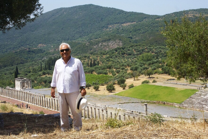 Archaeologist Petros Themelis (standing in front of the Doric stadium at Ancient Messene) has excavated at the site since 1986 and is considered a master at private fundraising for antiquities.