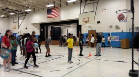 Mentors from Winston-Salem State University tudents play basketball at the Cook Literacy Model School gym