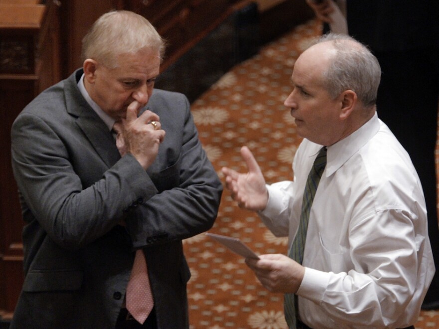 Reps. Dan Brady, right, R-Bloomington, and Roger Eddy, R-Hutsonville, confer on the Illinois House floor during a session at the state Capitol in Springfield, Ill., Tuesday.