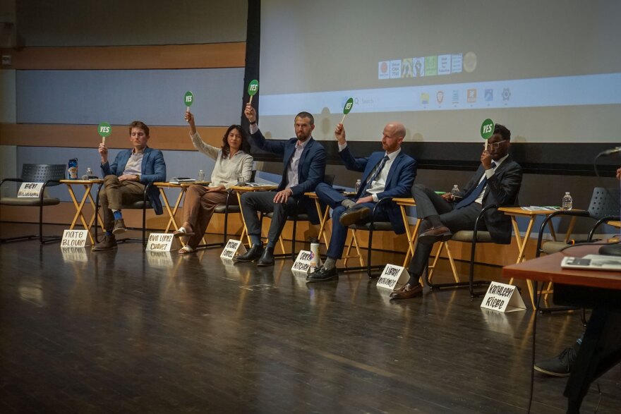 From left to right, candidates Nate Blouin, Eva Lopez Chavez, Michael Farrell, Derek Kitchen and Liban Mohamad show their opinion on political issues with a yes/no paddle at the beginning of a March 9, 2026, town hall organized by the 71 Percent Coalition and the Utah Chapter of Black Lives Matter.