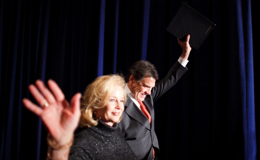 Texas Gov. Rick Perry and his wife, Anita, greet supporters after the Iowa caucuses.