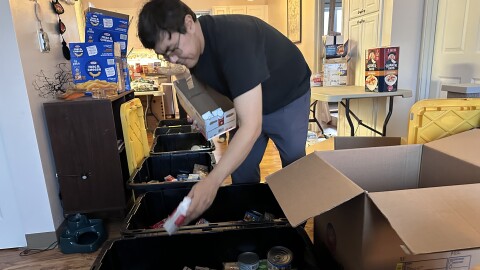 Kotzebue resident Joshua Hadley packages food boxes on Nov. 22. Northwest Arctic Takes Action plans to ship the boxes to the region's villages.