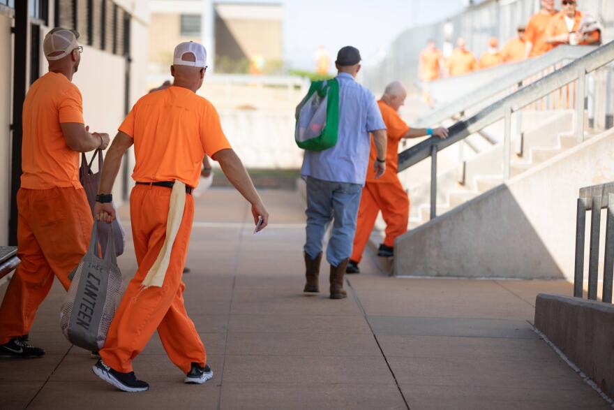 Prisoners walk the yard at the Joseph Harp Correctional Center in Lexington.