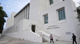 A law enforcement officer with the Department of Homeland Security, right, patrolled outside the Alto Lee Adams Sr. U.S. Courthouse in Fort Pierce as jury selection was set to begin in the trial of Ryan Routh.