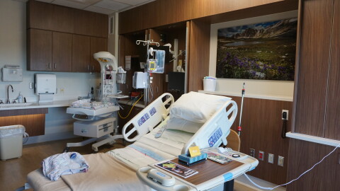 An empty hospital bed in a hospital room.