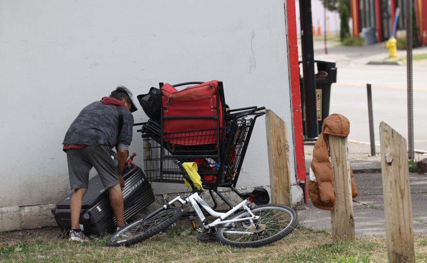 Homeless who were cleared of a vacant city lot on Burbank Street near North Clinton Avenue carry off what belonging they were able to gather after the city of Rochester sent in operations crews and police to clear the lot of tents and the people living in the vacant lot on Friday, July 25, 2025.
