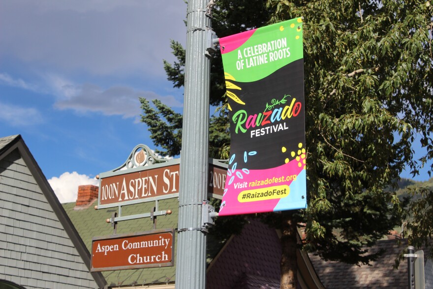 A banner advertising the Raizado Festival hangs on a poll in downtown Aspen on August 20, 2026.