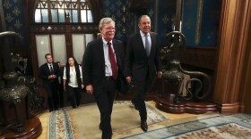U.S. National Security Adviser John Bolton, left, and Russian Foreign Minister Sergey Lavrov enter a hall for their talks in Moscow, Russia, Monday, Oct. 22, 2018. U.S. President Donald Trump's national security adviser has met with top Russian officials after Trump declared he intended to pull out of a 1987 nuclear weapons treaty. (Russian Foreign Ministry Press Service via AP)