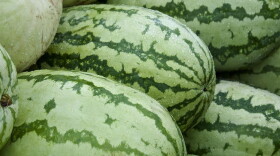 Nine watermelons stacked together.