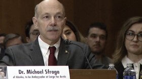 man in suit sitting at a table