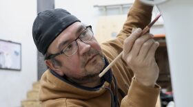 John Garcia III paints Petersburg’s killer whale canoe (kéet yaakw) on March 7, 2026.