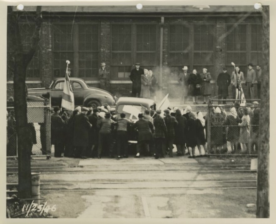 Strikers try to prevent a car from entering the Allis-Chalmers factory, November 25, 1946.