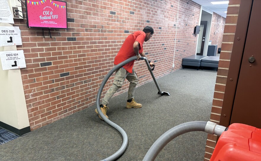 Crews clean up carpet inside ISU's DeGarmo Hall on Friday.