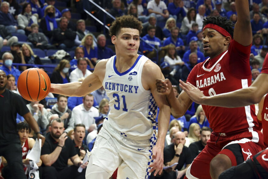 Kentucky's Kellan Grady (31) drives as Alabama's Noah Gurley, right, defends during the first half of an NCAA college basketball game in Lexington, Ky., Saturday, Feb. 19, 2022. (AP Photo/James Crisp)