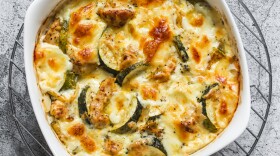 Zucchini, chicken, mozzarella cheese baked casserole on a grey background, top view