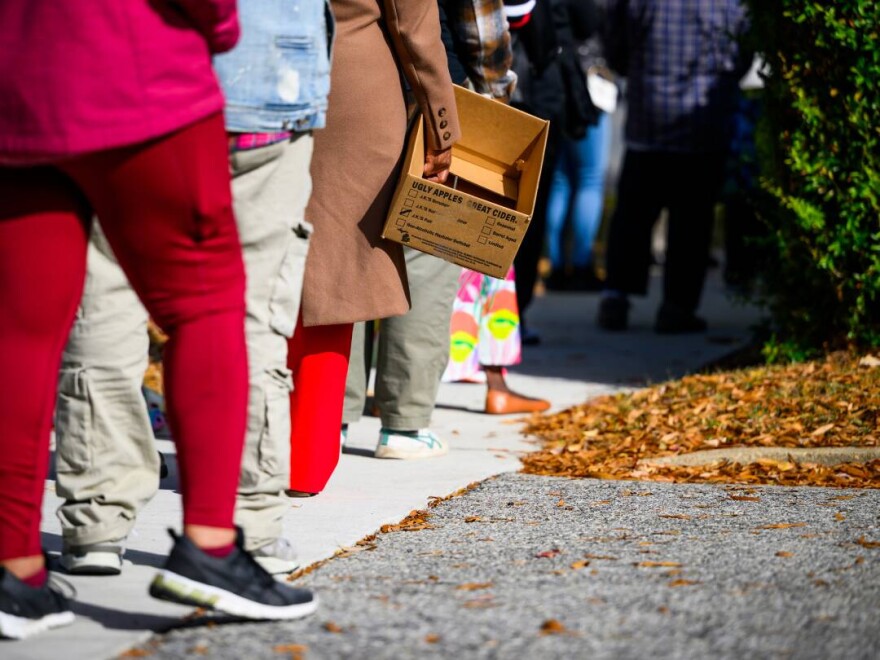 People wait in line this week at a Capital Area Food Bank distribution site in Hyattsville, Maryland. A new analysis shows millions of people may get even less food assistance than expected under the Trump administration's plan to partially fund SNAP during the government shutdown.