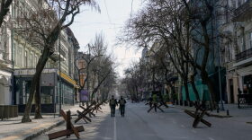 Soldiers walk in an empty street of Odessa.