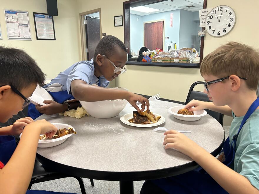  Prophet Ndungu joins other kids in preparing a plate of French Toast