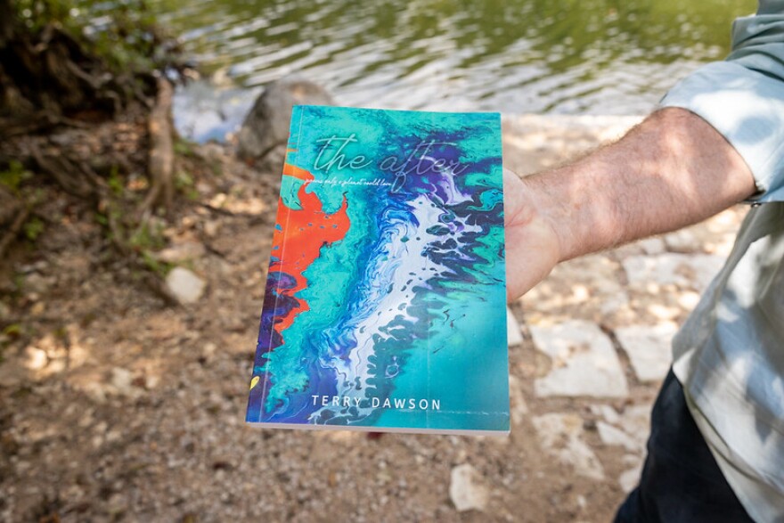 Austin poet Terry Dawson holds a copy of his collection of poems on climate change called "the after: poems only a planet could love." The cover art for the book is based on Austin artist Liam Wilson's painting "Planet's Tale in Fire and Ice."