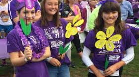 Young walkers show off the various colored "flowers" that signify participants' personal connection to the affliction.