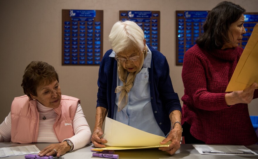 Eve Rey, 74, Angie Martinez, 88, and Maria Zurlinden, 68, sort and file election material at the El Paso County courthouse on Tuesday in El Paso, Texas.
