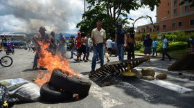 Anti-government activists set up a barricade in the streets of Venezuela's third city, Valencia, on Aug. 6, 2017, a day after a new assembly with supreme powers and loyal to President Nicolas Maduro started functioning in the country. In a video posted online earlier, allegedly at an army base used by the National Bolivarian Armed Forces in Valencia, a man presenting himself as an army captain declared a "legitimate rebellion ... to reject the murderous tyranny of Nicolas Maduro" and demanded a transitional government and "free elections." After the video surfaced, military chiefs said troops had put down the "terrorist" attack. (Ronaldo Schemidt/AFP/Getty Images)