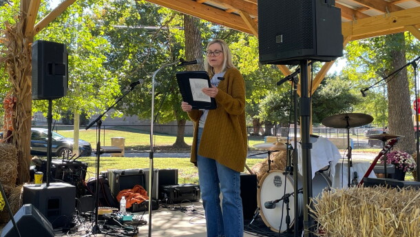 Indivisible Evansville President Wendy Bredhold speaks from the stage at Vote Fest in Evansville's Vann Park, Oct. 18, 2026