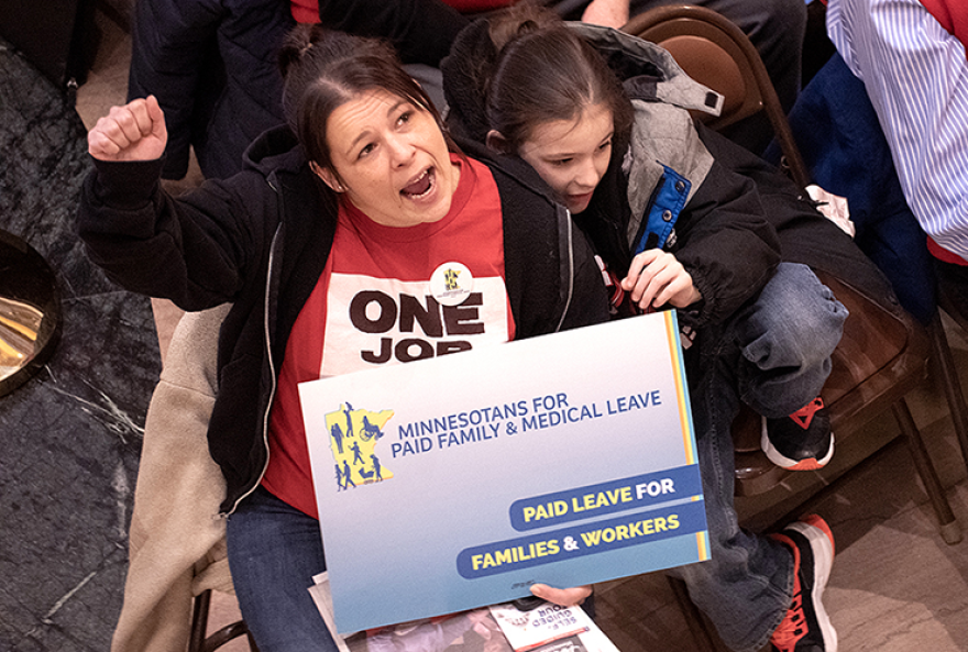 Leah Riley, a Rochester hospitality worker, along with her son, Riley Altom, rallies for Paid Family & Medical Leave in the Capitol Rotunda during the 2023 Minnesota legislative session.