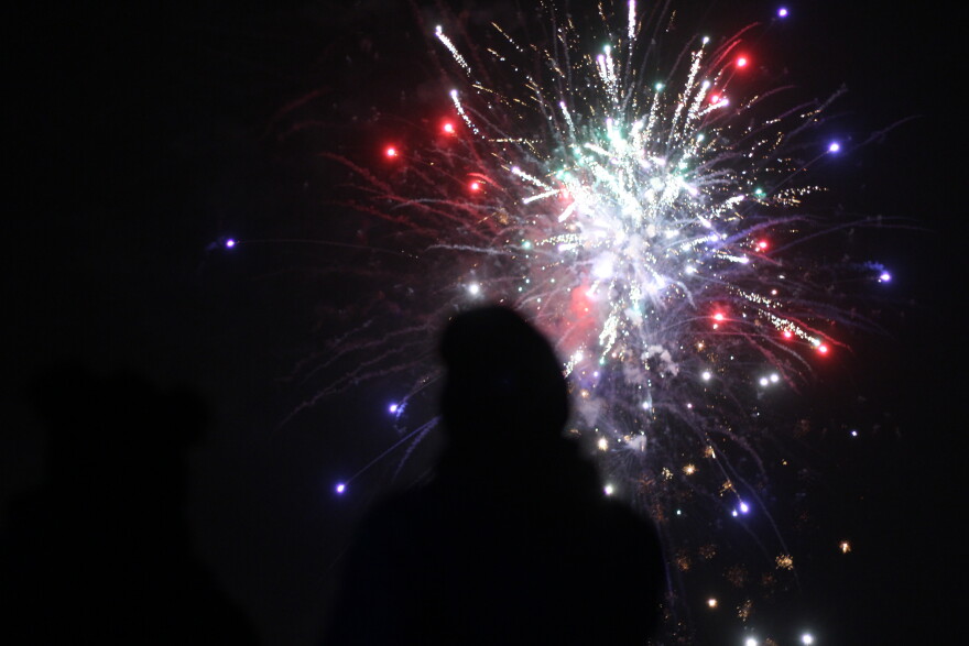 Alexander Burnor and his fiance Anita Monroe look on as Kotzebue celebrates the new year with fireworks on Jan. 1, 2020. 