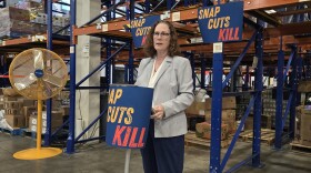 Rep. Val Hoyle speaks to members of the press at Food For Lane County's Eugene warehouse.