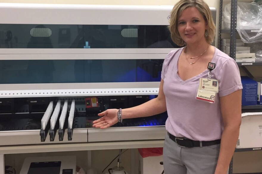 Melissa Randolph, cytopathology supervisor at Indiana University Health, shows a new piece of equipment in the lab.