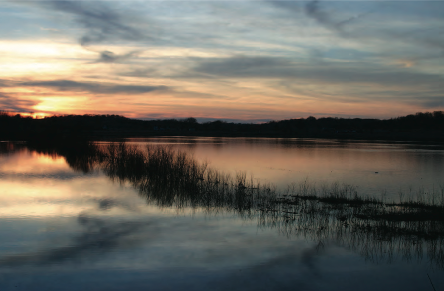 Sunset over an Emiquon backwater near Dickson Mounds highlights the potential of the 7,100-acre preserve to return to its natural state.