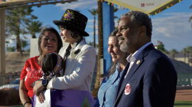 Tammi Tiger (left), Barbara Hartzell, Shea Backus, Steven Hoursford (right), stand in front of the Welcome to Las Vegas sign in honor of Indigenous Peoples Day on Oct. 12, 2026. (Jimmy Romo/KNPR)