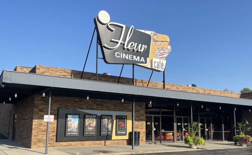 The exterior of Fleur Cinema & Café advertises the four "Now Playing" movies. 