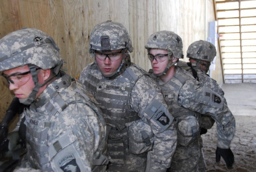 A team practices raiding a house during training at Fort Campbell.