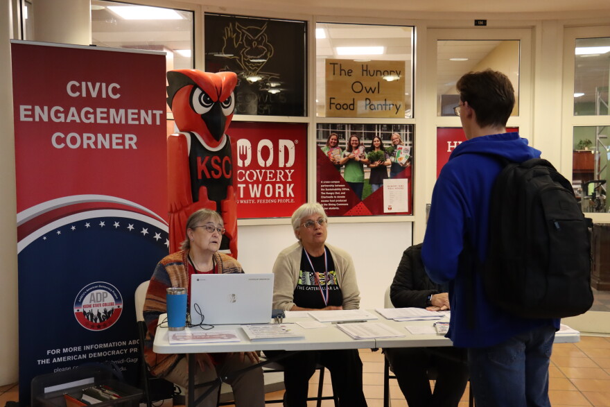 At a voter registration drive at Keene State College, staff from the city clerk's office help students register to vote and answer questions.