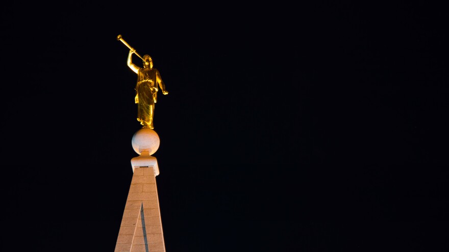 A photo of the Angel Moroni on top of a LDS temple. 