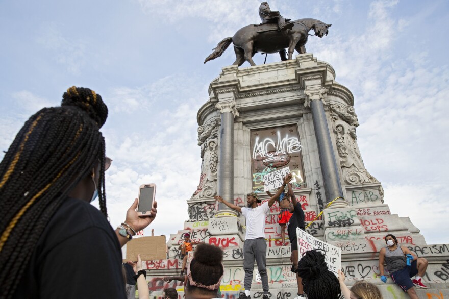 People gather around the Robert E. Lee statue on Monument Avenue in Richmond, Va., on June 4, amid continued protests over the death of George Floyd in police custody.