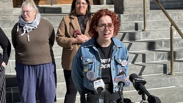 Jillian Moczara and a handful of others gather in front of city hall urging common councilors from entering into, renewing, or extending contracts with companies that profit from immigration enforcement efforts. Behind her are Genevieve Garcia, Kendrick, right, and Lee Cridland, left.