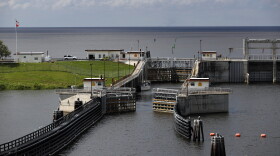 FILE: In this Friday, Oct. 25, 2019, 2019 photo, the doors of a lock open at Port Mayocca, Fla., allowing a sailboat to enter he St. Lucie Canal after leaving Lake Okeechobee, background. The lock and dam was built in 1977 to raise the water level in the lake and provide flood control.