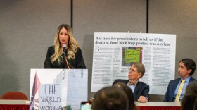 Laura Ah Loo, widow of Afa Ah Loo, speaks at a news conference held by her attorneys at the Utah State Bar, Oct. 29, 2025. She stood in front of a picture of her husband at the June protest, where he was fatally shot holding a sign that said, "The World is Watching."